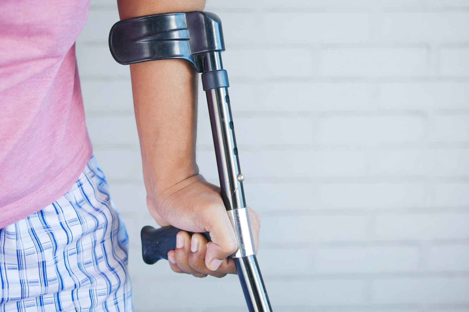 A person standing with a crutch