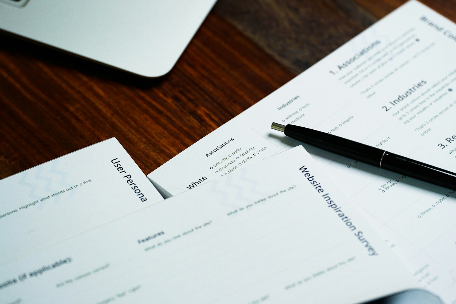 A pen resting on a pile of insurance forms